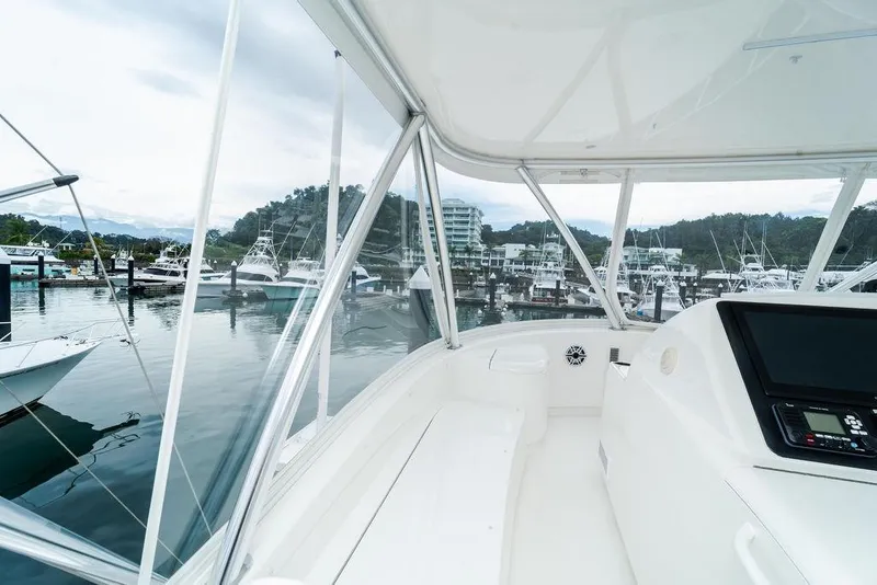 Slide: The Image of 2021 Viking 58 Convertible yacht interior with marina view, showcasing luxury and modern design. - 32