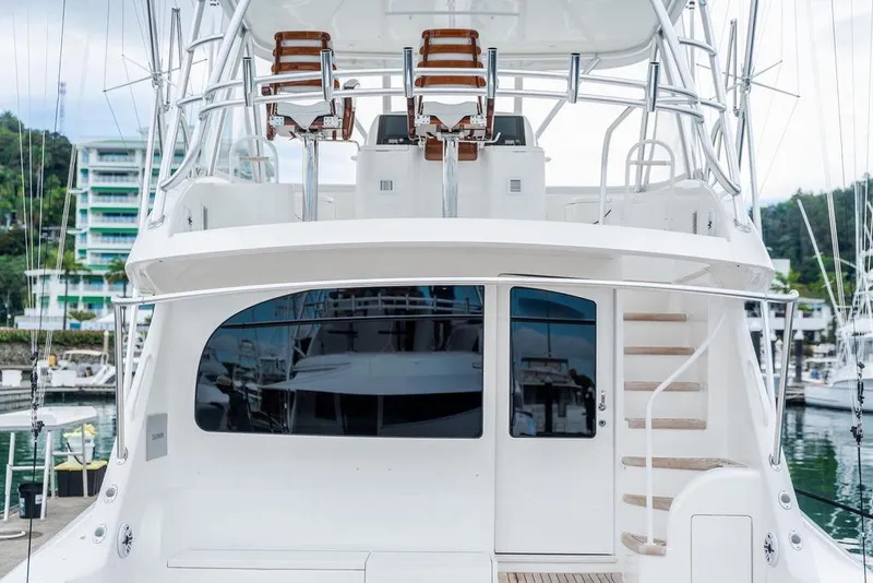 Slide: The Image of 2021 Viking 58 Convertible yacht docked at marina, featuring sleek design and upper deck seating. - 39