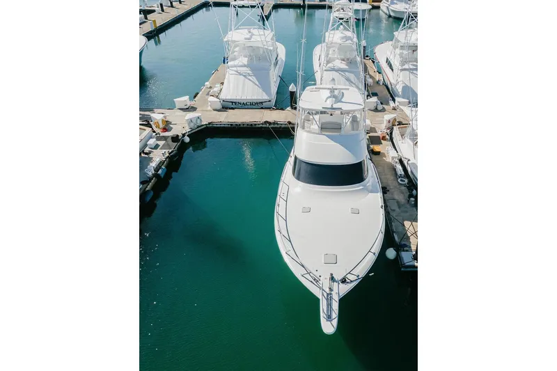 Slide: The Image of Aerial view of a 2021 Viking 58 Convertible yacht docked in a marina. - 45