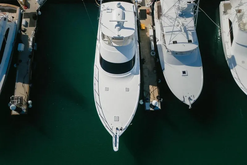 Slide: The Image of Aerial view of a 2021 Viking 58 Convertible yacht docked at a marina. - 52