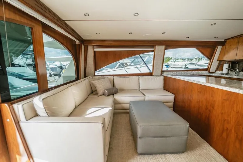 Slide: The Image of Luxurious interior of 2021 Viking 58 Convertible yacht with plush seating and elegant wood finishes. - 61