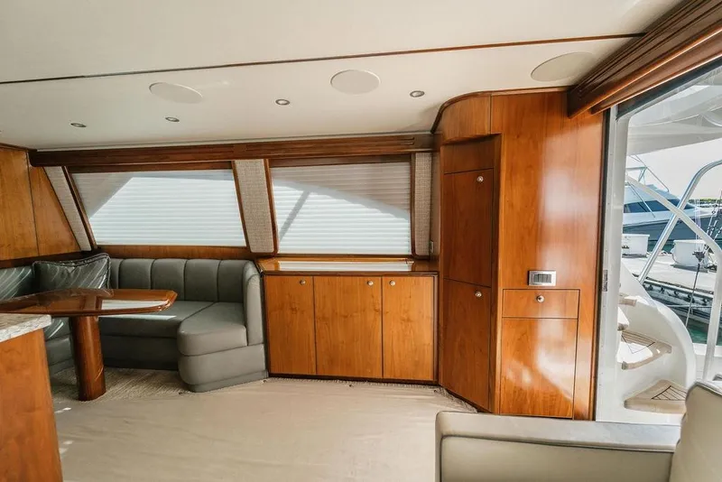 Slide: The Image of Luxurious interior of 2021 Viking 58 Convertible yacht with wood finishes and seating area. - 63