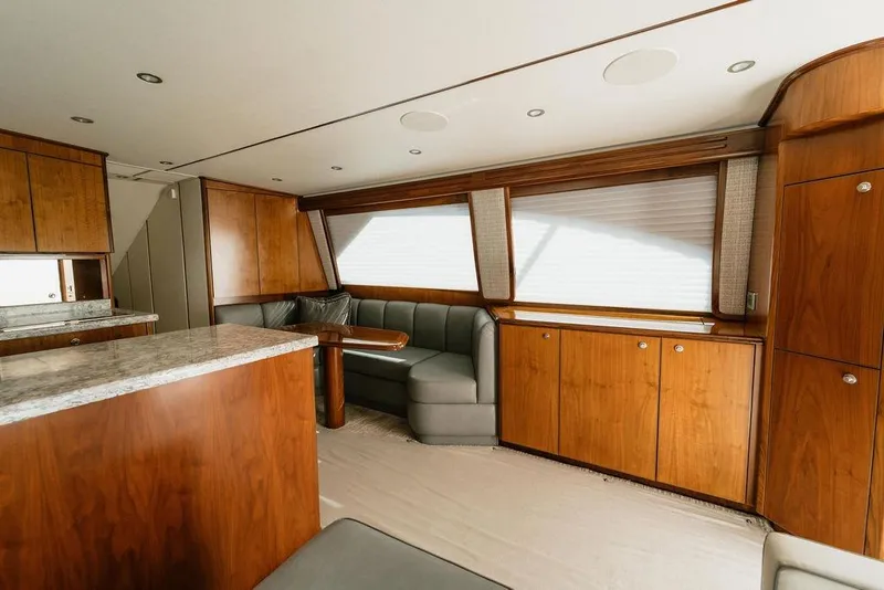 Slide: The Image of Luxurious interior of 2021 Viking 58 Convertible yacht with wood cabinetry and plush seating. - 64