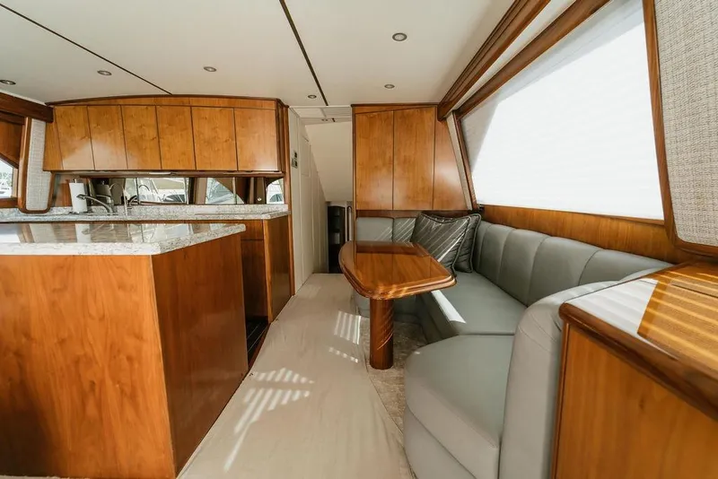 Slide: The Image of Luxurious interior of 2021 Viking 58 Convertible yacht with wood finishes and plush seating. - 65