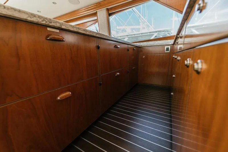 Slide: The Image of Luxurious wooden cabinetry inside a 2021 Viking 58 Convertible yacht kitchen. - 67