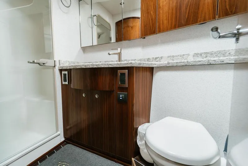 Slide: The Image of Luxurious bathroom in 2021 Viking 58 Convertible yacht with modern fixtures and wood cabinetry. - 73