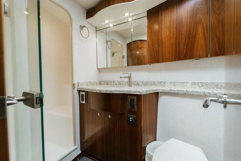 Slide: The Image of Luxurious bathroom in 2021 Viking 58 Convertible yacht with wood cabinetry and modern fixtures. - 78