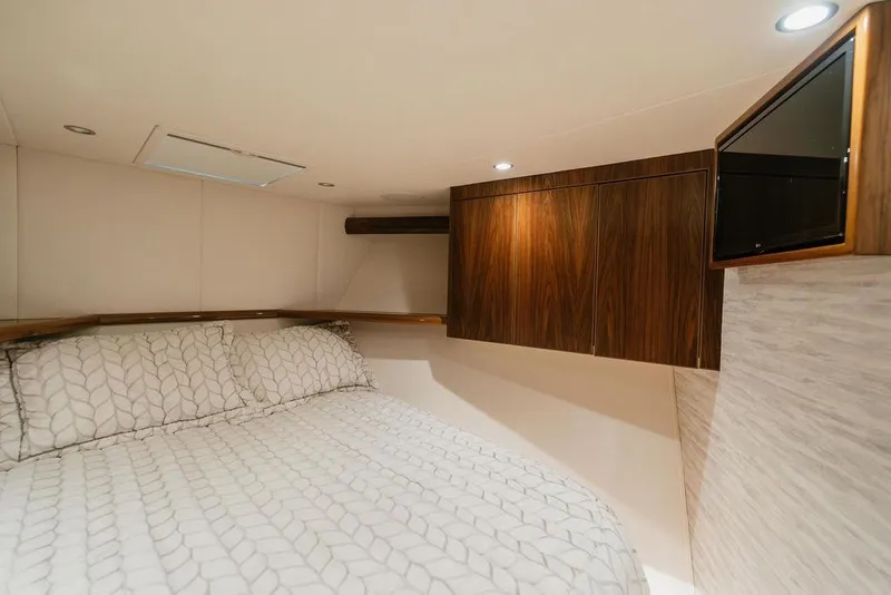 Slide: The Image of Luxurious bedroom interior of 2021 Viking 58 Convertible yacht with elegant wood cabinetry. - 81