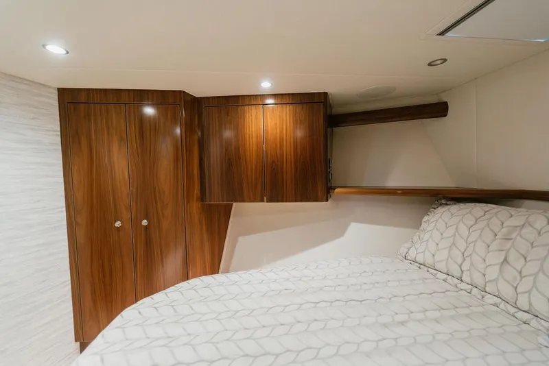 Slide: The Image of Luxurious cabin interior of 2021 Viking 58 Convertible yacht with wood cabinetry and cozy bedding. - 82