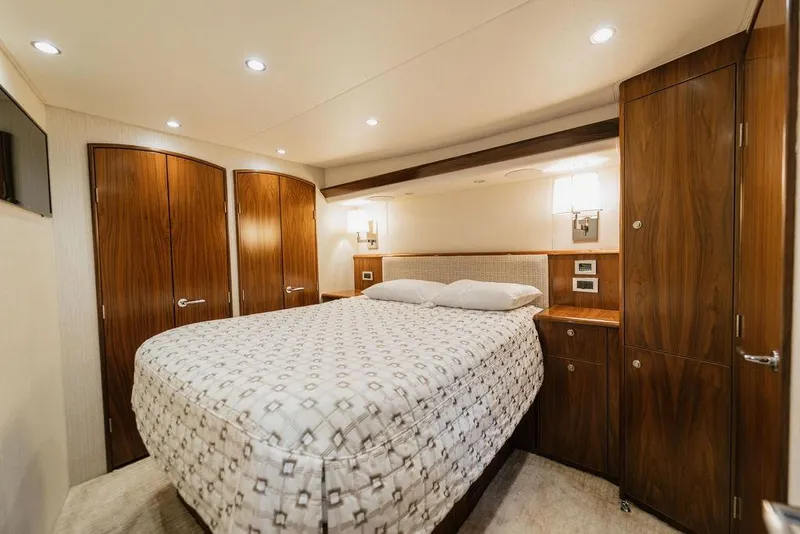 Slide: The Image of Luxurious bedroom interior of 2021 Viking 58 Convertible yacht with wood accents. - 85