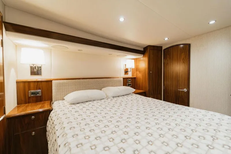 Slide: The Image of Luxurious bedroom interior of 2021 Viking 58 Convertible yacht with elegant wood finishes. - 86