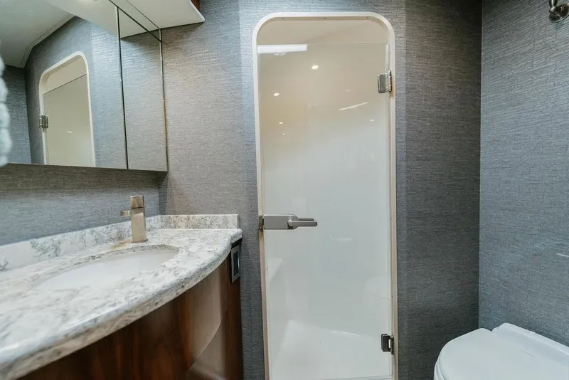 Slide: The Image of Luxurious bathroom in 2021 Viking 58 Convertible yacht with modern fixtures and elegant design. - 87