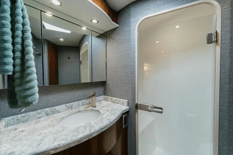 Slide: The Image of Luxurious bathroom in 2021 Viking 58 Convertible yacht with marble countertop and modern fixtures. - 88