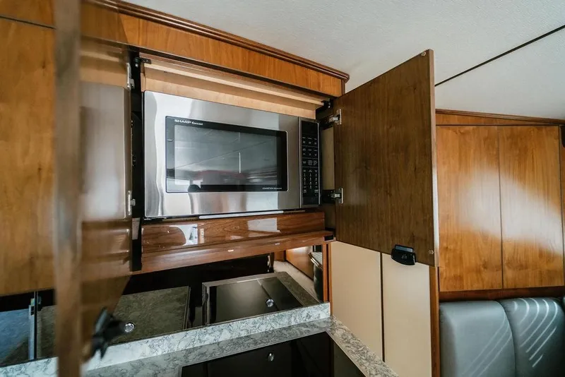 Slide: The Image of Microwave in 2021 Viking 58 Convertible yacht kitchen with wooden cabinetry. - 93
