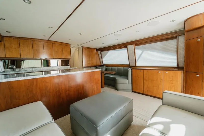 Slide: The Image of Luxurious interior of 2021 Viking 58 Convertible yacht with wood cabinetry and plush seating. - 98