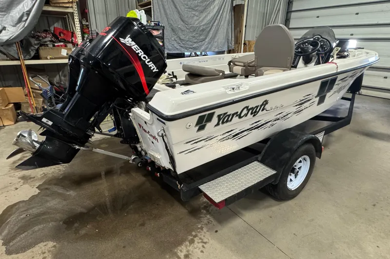 Slide: The Image of 2000 Yar-Craft 1785 Mille Lacs boat with Mercury outboard motor in a garage. - 4