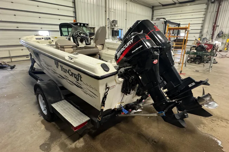 Slide: The Image of 2000 Yar-Craft 1785 Mille Lacs boat with Mercury outboard in a garage setting. - 5
