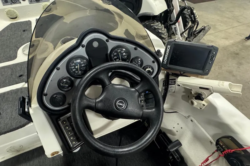 Slide: The Image of 2000 Yar-Craft 1785 Mille Lacs boat dashboard with steering wheel and Lowrance fish finder. - 7