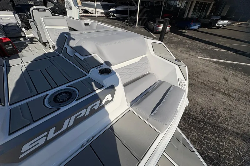 Slide: The Image of 2026 Supra SL 450 boat interior with sleek gray seating and modern design. - 14
