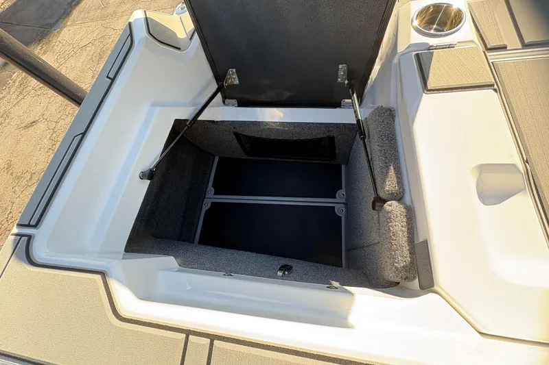 Slide: The Image of 2026 Supra SL 450 boat storage compartment with open lid, showcasing interior space. - 15