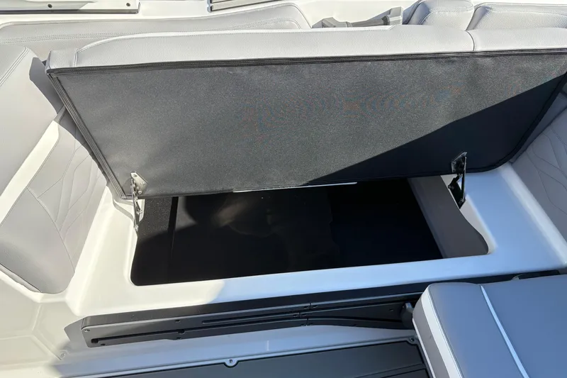 Slide: The Image of Open storage compartment in 2026 Supra SL 450 boat with gray seating. - 21