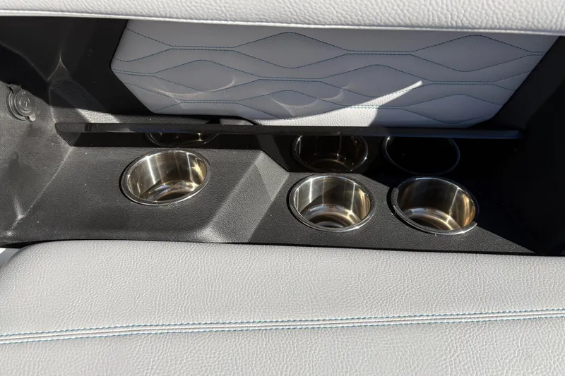 Slide: The Image of 2026 Supra SL 450 interior cup holders with sleek leather and stitching design. - 22
