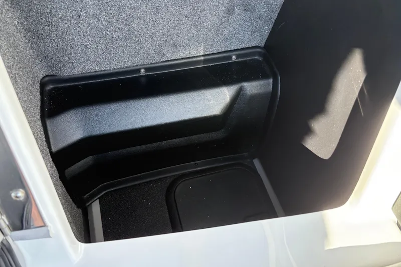 Slide: The Image of 2026 Supra SL 450 interior storage compartment with black and gray design. - 24