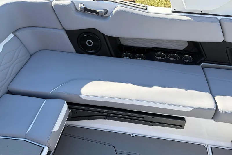 Slide: The Image of 2026 Supra SL 450 boat interior with gray seating and built-in cup holders. - 25