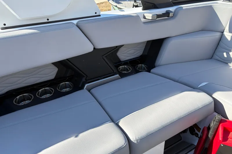 Slide: The Image of 2026 Supra SL 450 boat interior with gray seating and cup holders. - 27