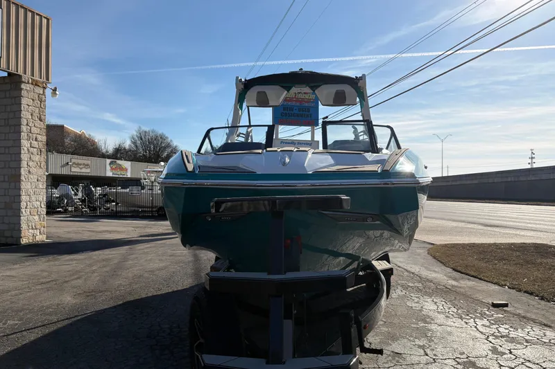 Slide: The Image of 2026 Supra SL 450 boat on trailer, parked outdoors under clear blue sky. - 3