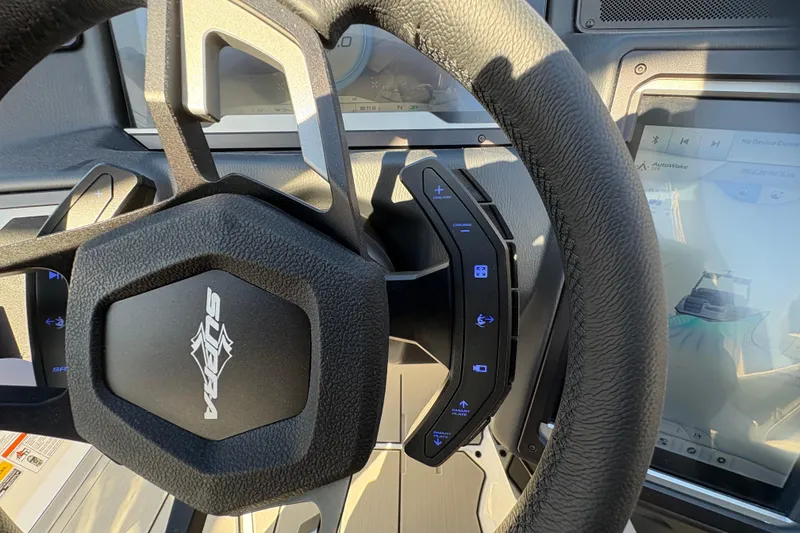 Slide: The Image of 2026 Supra SL 450 steering wheel with control buttons and digital display. - 38