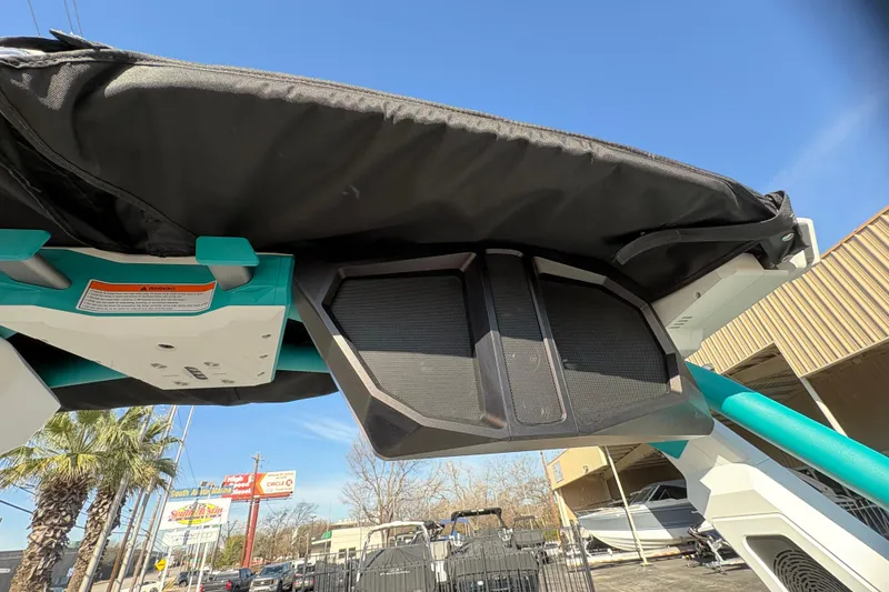 Slide: The Image of 2026 Supra SL 450 boat with canopy and speaker system, under clear blue sky. - 45