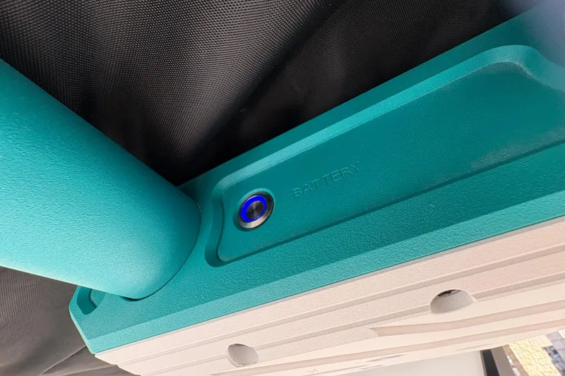 Slide: The Image of 2026 Supra SL 450 battery compartment with teal casing and button. - 47