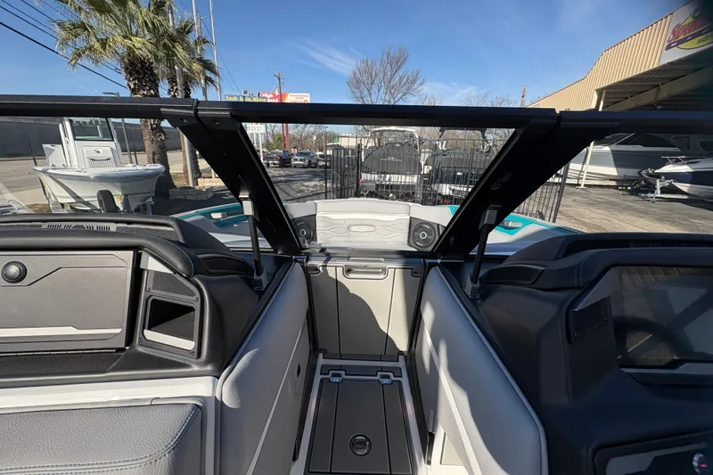 Slide: The Image of 2026 Supra SL 450 boat interior with modern dashboard and seating, parked outdoors. - 53