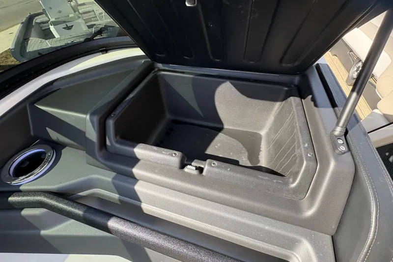 Slide: The Image of Open storage compartment in 2026 Avalon Exalibur LTD 27 Elite Windshield boat. - 20