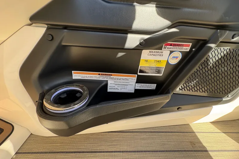 Slide: The Image of Interior of 2026 Avalon Exalibur LTD 27 Elite, featuring cup holder and safety labels. - 25