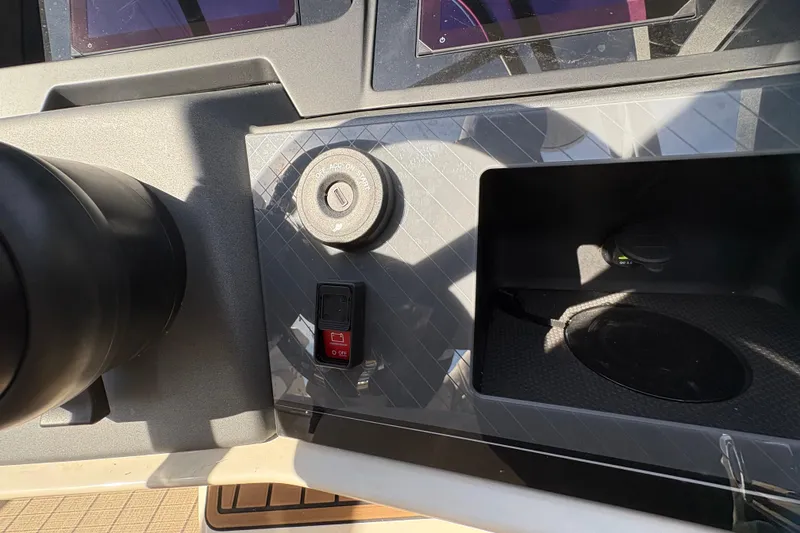 Slide: The Image of Control panel of 2026 Avalon Exalibur LTD 27 Elite Winshield boat, featuring ignition and switches. - 29