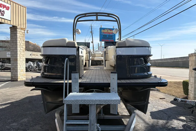 Slide: The Image of 2026 Avalon Exalibur LTD 27 Elite Windshield boat on display at dealership. - 3