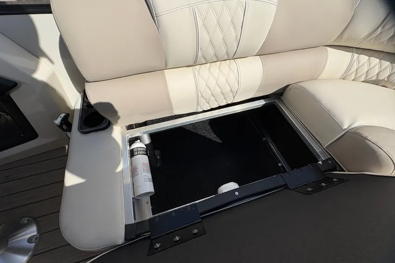 Slide: The Image of 2026 Avalon Exalibur LTD 27 Elite Windshield boat seat with storage compartment open. - 32