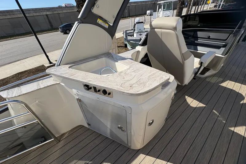 Slide: The Image of 2026 Avalon Exalibur LTD 27 Elite boat interior with sink and seating. - 34