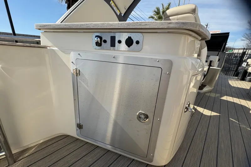 Slide: The Image of 2026 Avalon Exalibur LTD 27 Elite Windshield boat interior with storage compartment. - 38