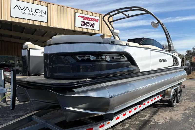 Slide: The Image of 2026 Avalon Exalibur LTD 27 Elite Windshield luxury pontoon boat on trailer. - 4