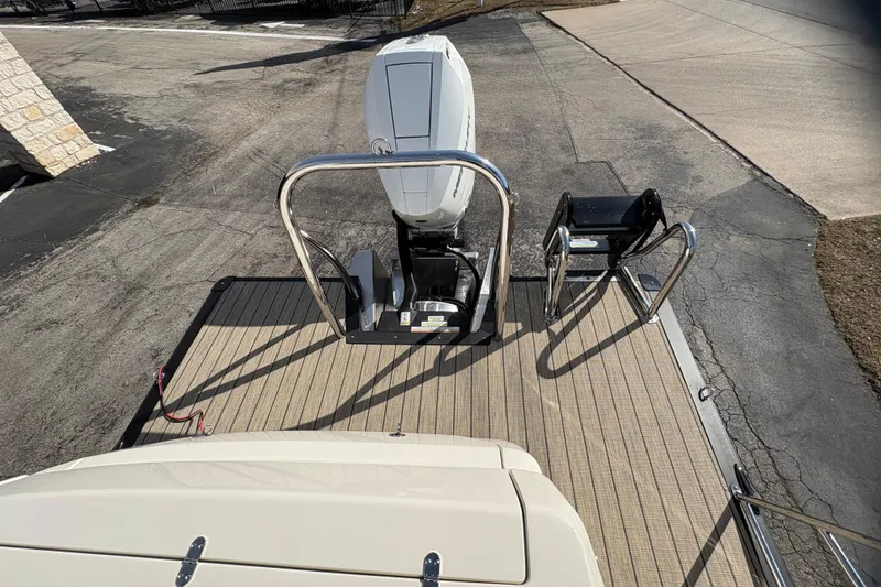 Slide: The Image of 2026 Avalon Exalibur LTD 27 Elite boat with outboard motor and deck view. - 42