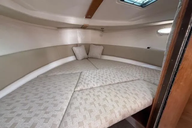 Slide: The Image of 2026 Cutwater C-288 Coupe interior cabin with cozy bedding and cushions. - 11