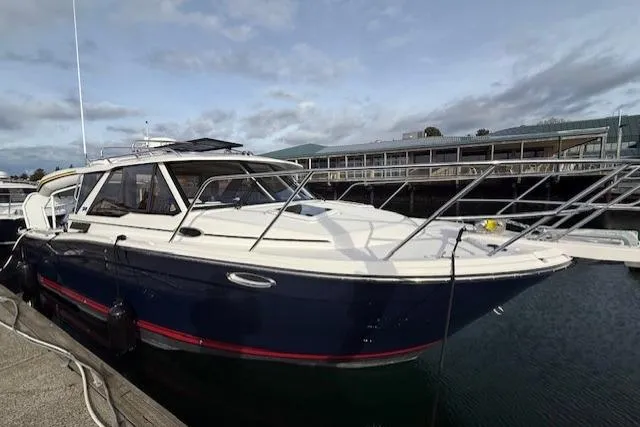 Slide: The Image of 2026 Cutwater C-288 Coupe boat docked at marina under cloudy sky. - 2