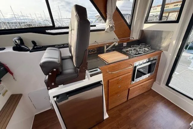Slide: The Image of 2026 Cutwater C-288 Coupe interior with kitchen, stove, and seating. - 7