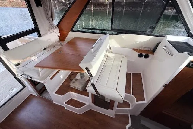 Slide: The Image of Interior of 2026 Cutwater C-288 Coupe, featuring seating and dining area with wood accents. - 9
