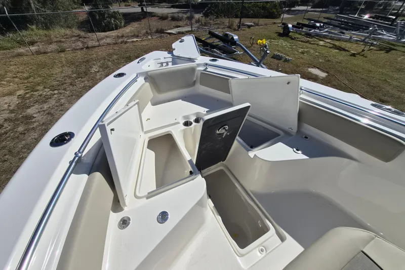 Slide: The Image of 2026 Key West 239 FS boat with open storage compartments and cup holders. - 11