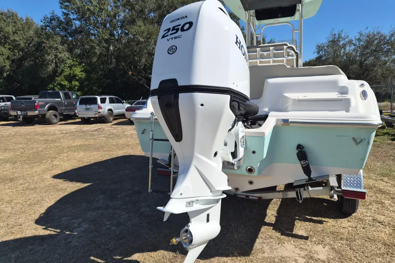 Slide: The Image of 2026 Key West 239 FS boat with Honda 250 VTEC engine in a parking area. - 13