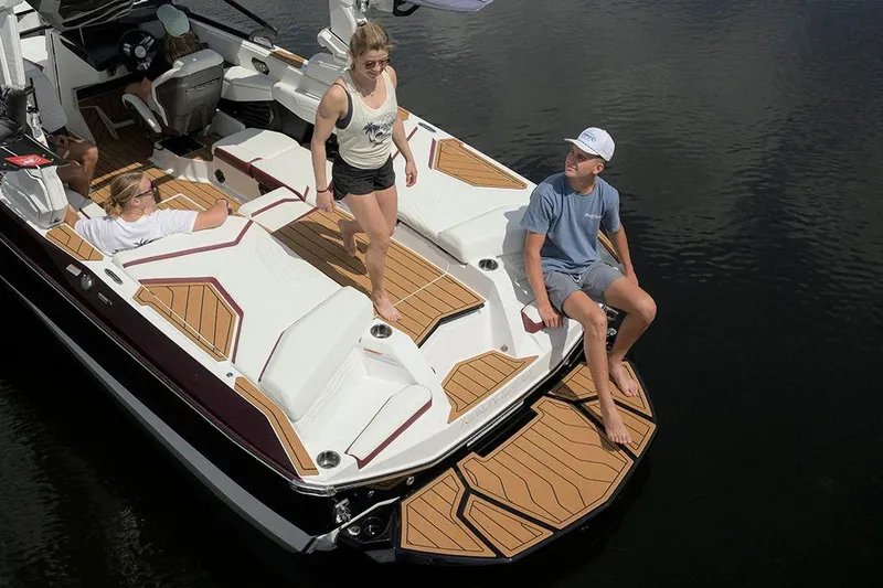 Slide: The Image of 2026 Nautique Super Air Nautique G21 with passengers enjoying the deck on a sunny day. - 10